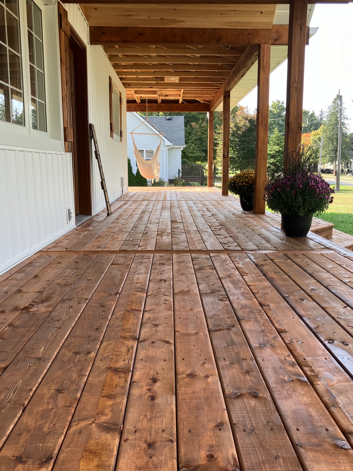 Covered porch deck boards and wood posts by Cutting Edge Carpentry