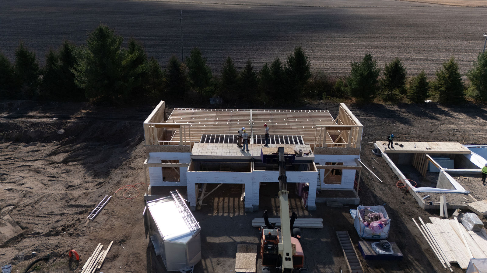 Aerial view of custom home framing and surrounding jobsite