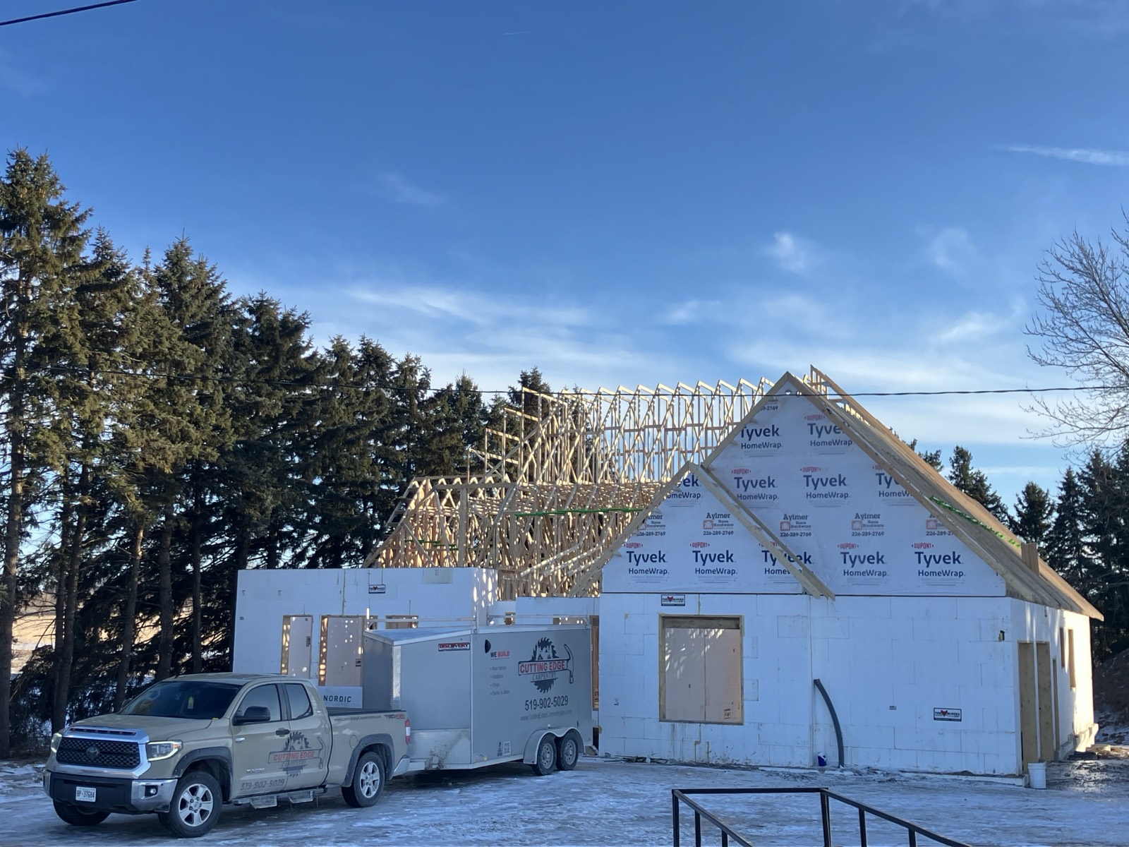 Custom home framing project with Cutting Edge Carpentry truck on site