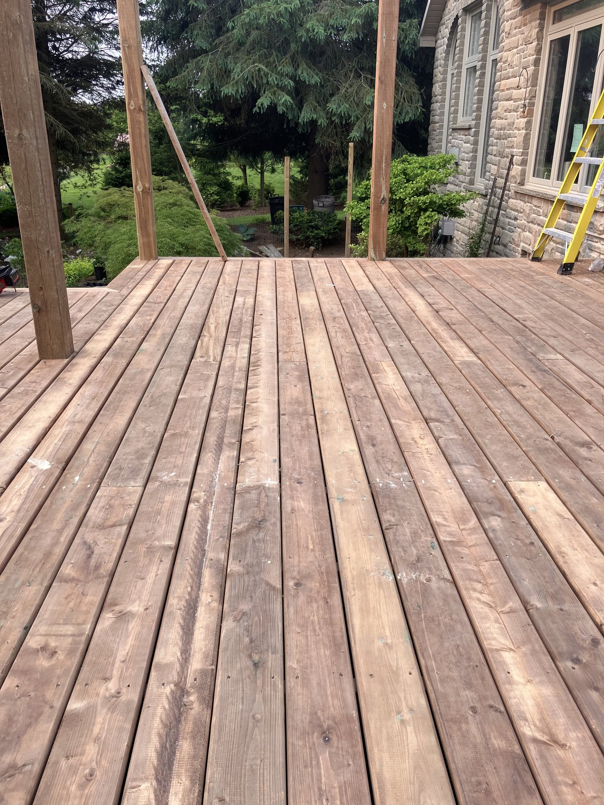 Deck board layout in progress beside the home