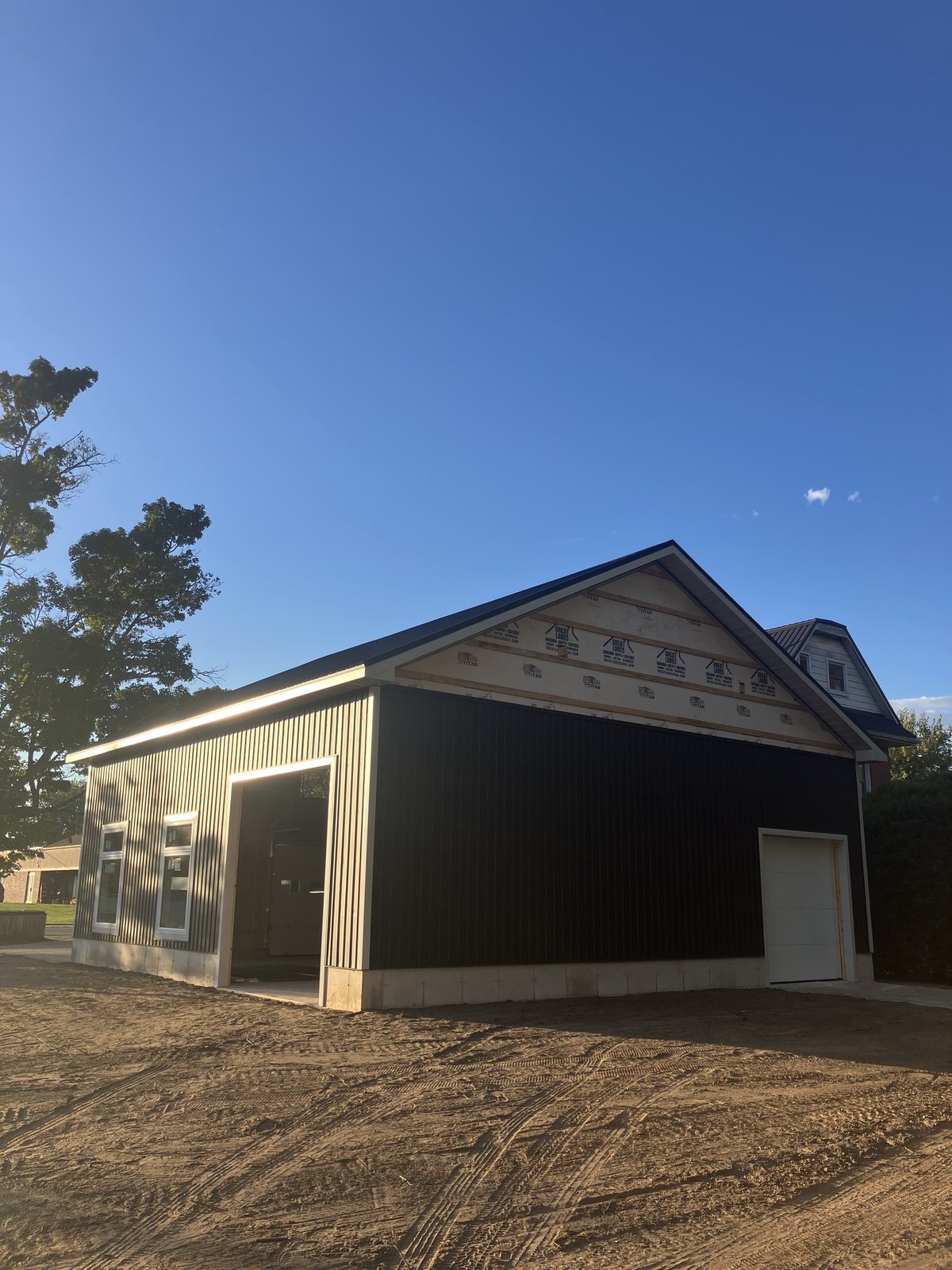 Detached garage and shop door opening with exterior cladding