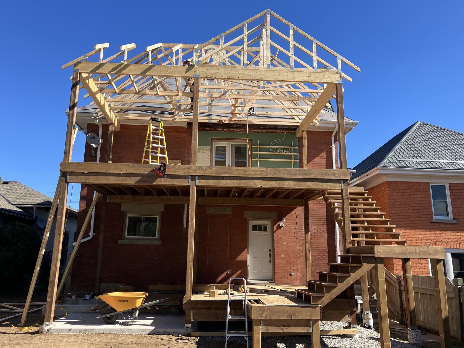 Raised deck roof framing with temporary supports in place