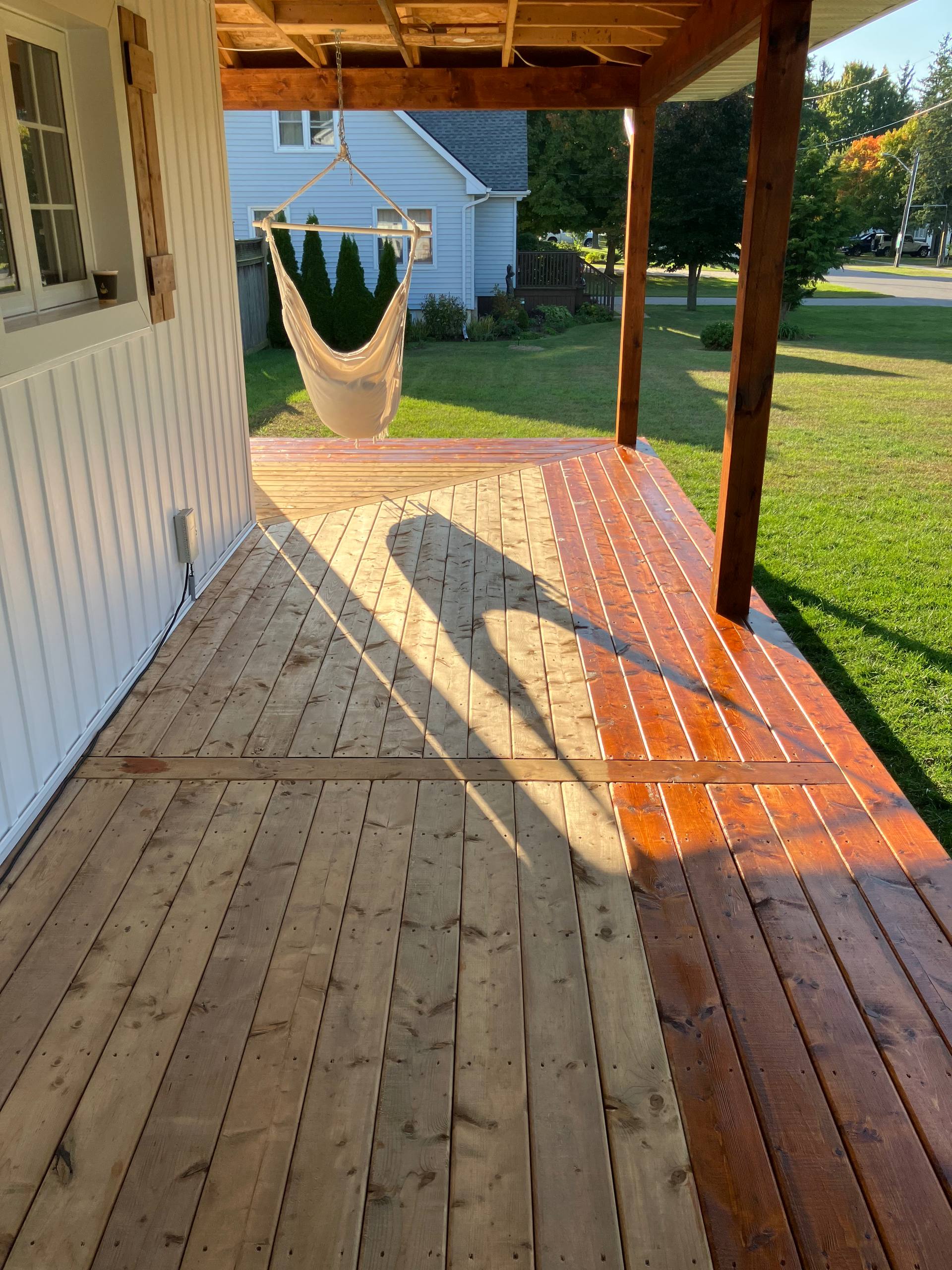 Covered deck with freshly refinished boards and protected exterior wood