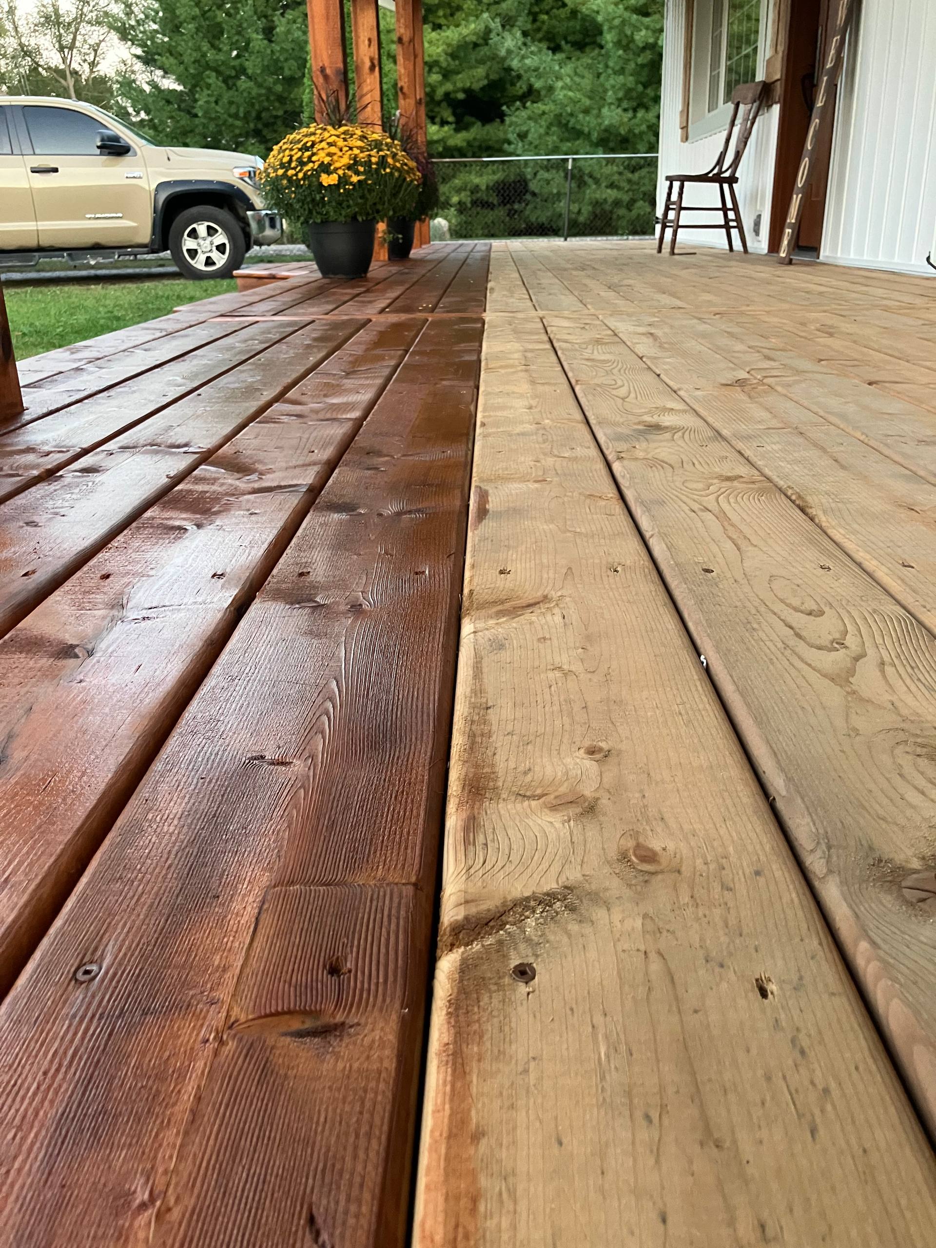 Deck boards showing refinished wood beside weathered wood before refinishing